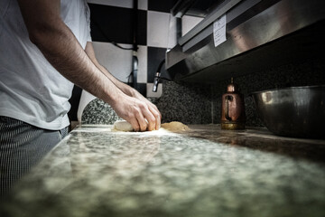 Pizza napoletana in preparation by pizzaiolo