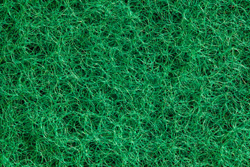 Fleecy fibrous synthetic green threads surface sponge close-up macro background wallpaper, uniform texture pattern