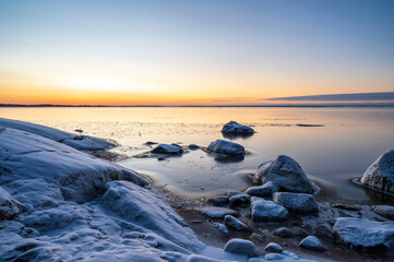 Sunset over the frozen sea and beach. Pörkenäs, Jakobstad/Pietarsaari, Finland