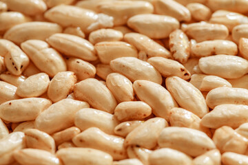 Air rice oval in dry sweet syrup close-up, side view, selective focus