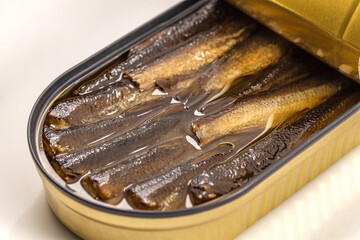 Sprats in oil, opened can of canned fish, selective focus