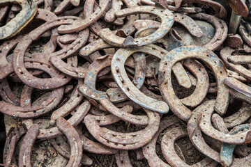 Pile of old used and rusty horseshoes
