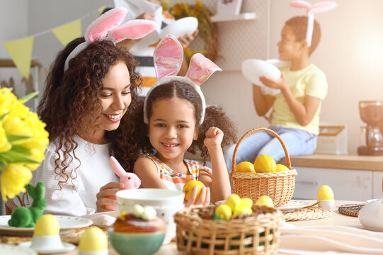 Little African-American girl and her mother celebrating Easter at home