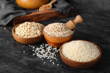 Bowls with cereals on dark background