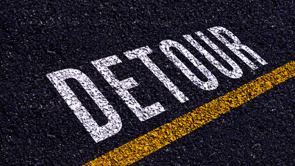 Obraz premium Detour written and yellow line on the road in middle of the asphalt road, Detour word on street.