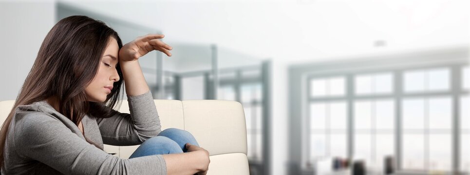 Young sad person sits at home. Problems concept