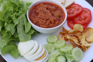 Homemade Muslim salad with sweet sauce on wood table background. Green salad halal food on plate. 