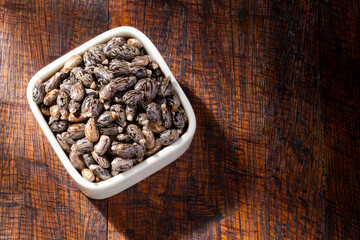 Castor grains and oil on the table, close-up image