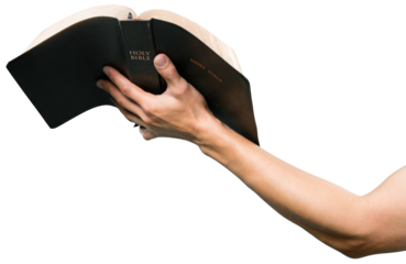 Human hand holding the saint book