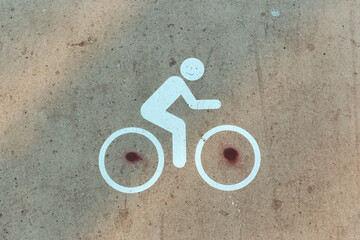 Bycicle traffic signs and circulation markings on the ground with graffiti