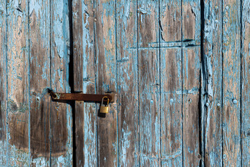 Rustic antique door on a traditional Algarve building facade
