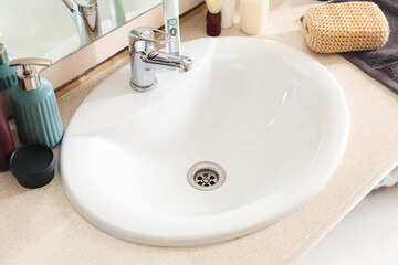 Table with white sink and bath supplies