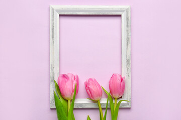 Composition with empty picture frame and beautiful tulip flowers on lilac background