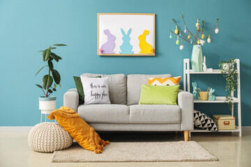 Interior of living room with Easter decor, sofa and shelving unit
