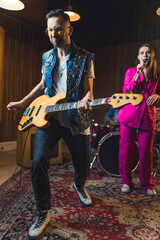 Bass guitar player dancing during the rehearsal. High quality photo