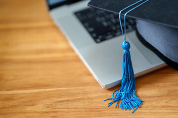 Black Graduation Cap with on laptop Knowledge Online education concept