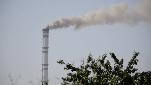 industrial chimneys with heavy brownish black smoke causing the problem of air pollution and global warming. environmental problems in industrial enterprises