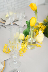 Festive table setting with baby chickens and bunnies for Easter celebration