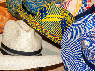Colorful Handmade and clasic Panama Hats or Paja Toquilla hats or sombreros at the traditional...