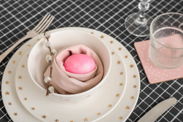 Table setting with painted egg and pussy willow branch in bowl served for Easter celebration