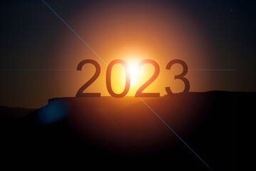 Silhouette of dark 2023 numbers with sunset sky