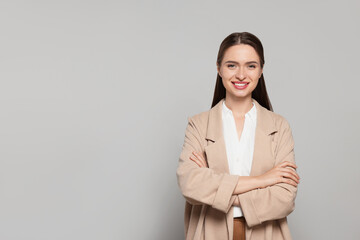 Portrait of beautiful young teacher on grey background. Space for text