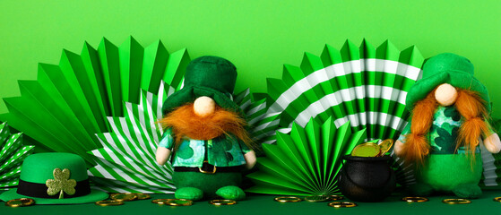 St. Patrick's Day banner template. Green background with paper folding fans, leprechauns, clover leaves, pot of gold.