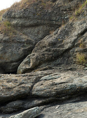 Black Sea coast. A seashore formed by frozen volcanic lava. Tectonic rocks.