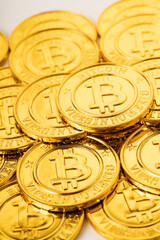 A pile of golden bitcoins placed together