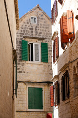 Picturesque narrow street with stone houses. Trogir, Dalmatia, Croatia, Europe