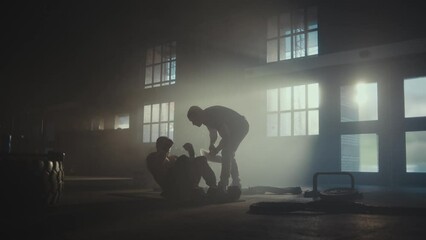 Caucasian fit man exercising with personal trainer in gym, energetic physical activity of strong young male doing push-ups - Powered by Adobe