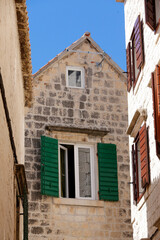 Fototapeta na wymiar Picturesque narrow street with stone houses. Trogir, Dalmatia, Croatia, Europe