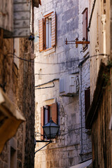 Picturesque narrow street with stone houses. Trogir, Dalmatia, Croatia, Europe