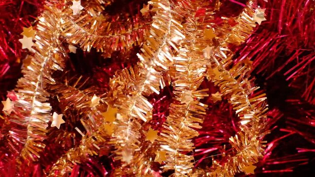 Tinsel red and gold. Shiny festive tinsel texture. Christmas New Year holidays and party background.4k footage