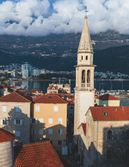 Naklejka premium View of Budva old town streets, Budva Municipality and Riviera, resort on the Adriatic sea coast, Montenegro, sunny day with a blue sky, cathedral and citadel, travel to Montenegro
