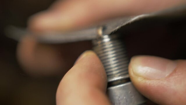 Cleaning spark plug using sandpaper Close up realtime
