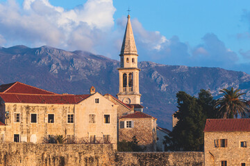 Fototapeta premium View of Budva old town streets, Budva Municipality and Riviera, resort on the Adriatic sea coast, Montenegro, sunny day with a blue sky, cathedral and citadel, travel to Montenegro