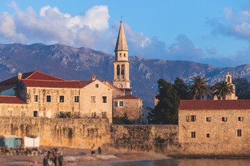 Fototapeta na wymiar View of Budva old town streets, Budva Municipality and Riviera, resort on the Adriatic sea coast, Montenegro, sunny day with a blue sky, cathedral and citadel, travel to Montenegro