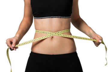 Female fitness model holding a tape measurer around her waist - weightloss concept