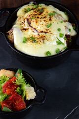 rice with meat sausage bacon and melted cheese served with salad and bread toast