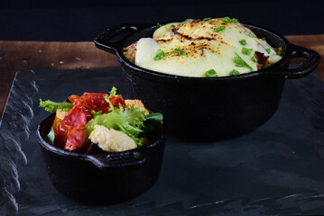 rice with meat sausage bacon and melted cheese served with salad and bread toast