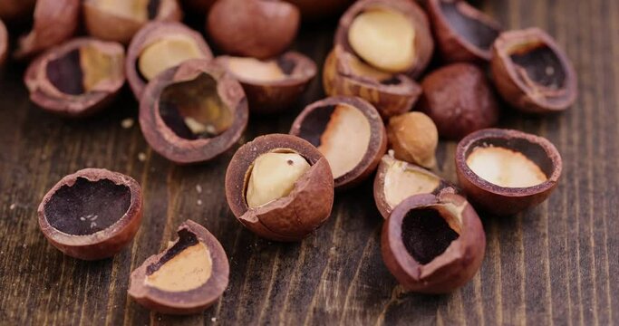 peel macadamia nuts on the table, crispy dried macadamia nuts together with thick and hard shells