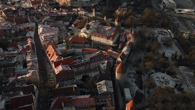 Top down aerial view over town walls of Tallinn during sunset - February 2023