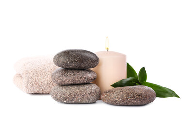 Obraz na płótnie Canvas Spa stones, candle, towel and bamboo leaves on white background