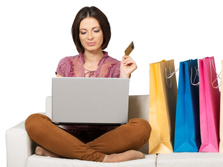 Woman Sitting on the Couch with Laptop, Credit Card and Shopping Bags