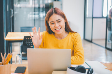 young student wearing headphones studies online, distance learning, and keeps up to date on the global coronavirus pandemic.