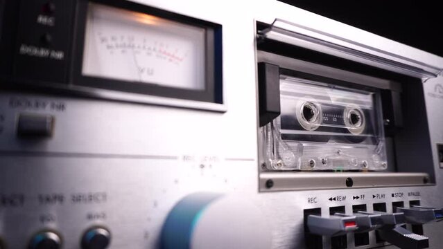Audio Cassette Deck Player With VU Meter and Rolling Cassette Tape, Close Up Selected Focus
