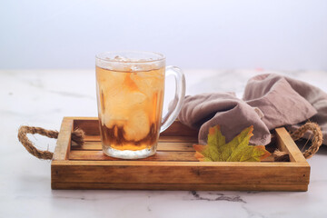 Traditional Ice Tea in a glass on wodden tray
