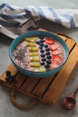 Smoothie bowl with fresh blueberries, kiwi, strawberry, and chia seeds
