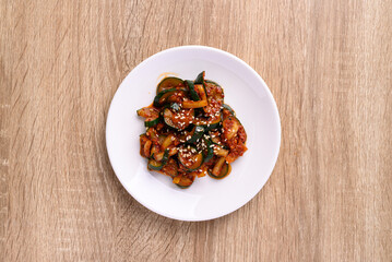 Fototapeta na wymiar Kimchi cucumber on wooden background, Korean food side dish, Table top view